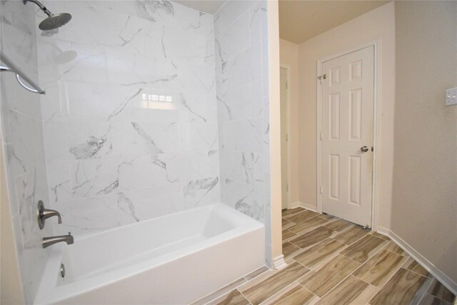 2305 Love Rd, Killeen, TX 76542 - bathroom featuring  shower combination, wood finish floors, and baseboards