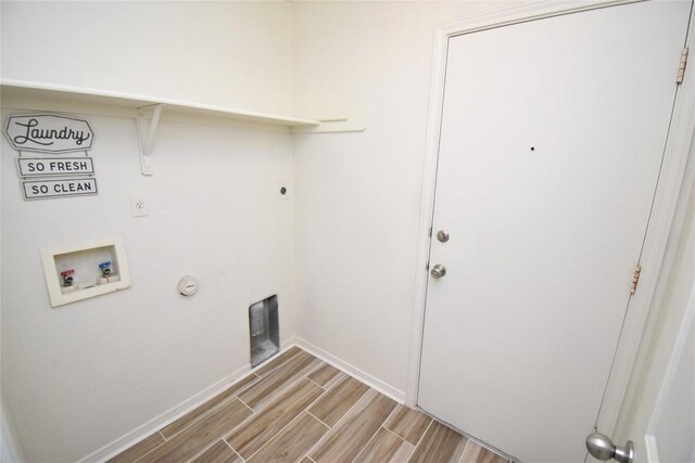 2305 Love Rd, Killeen, TX 76542 - laundry room featuring hookup for a washing machine, wood tiled floors, hookup for an electric dryer, hookup for a gas dryer, and baseboards