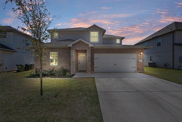 506 Windy Reed Rd, Hutto, TX 78634 - traditional-style home with brick siding, driveway, and a lawn