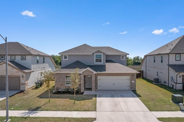 506 Windy Reed Rd, Hutto, TX 78634 - traditional-style house featuring concrete driveway, a front lawn, roof with shingles, and a garage