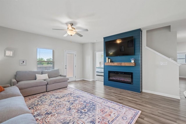 506 Windy Reed Rd, Hutto, TX 78634 - living room with a ceiling fan, wood finished floors, and a fireplace