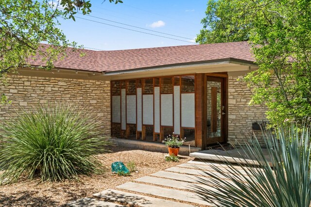 5322 Western Hills Dr, Austin, TX 78731 - entrance to property with roof with shingles and stone siding