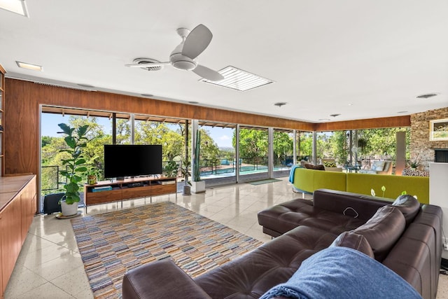 5322 Western Hills Dr, Austin, TX 78731 - living area featuring wood walls, a ceiling fan, visible vents, and light speckled floor
