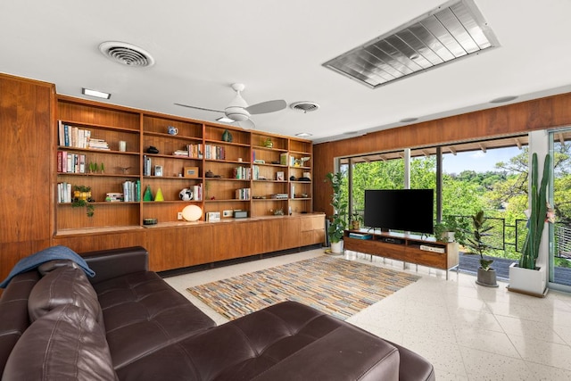 5322 Western Hills Dr, Austin, TX 78731 - living room with wooden walls, visible vents, light speckled floor, and ceiling fan