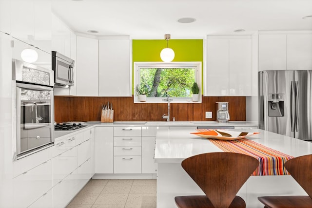 5322 Western Hills Dr, Austin, TX 78731 - kitchen with stainless steel appliances, light countertops, and white cabinetry