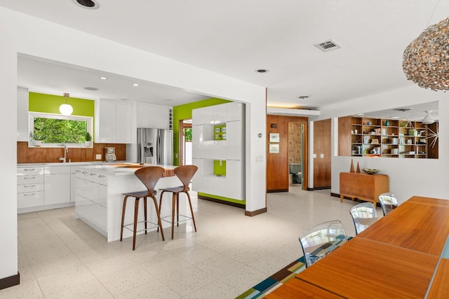 5322 Western Hills Dr, Austin, TX 78731 - kitchen featuring white cabinets, stainless steel refrigerator with ice dispenser, visible vents, and modern cabinets