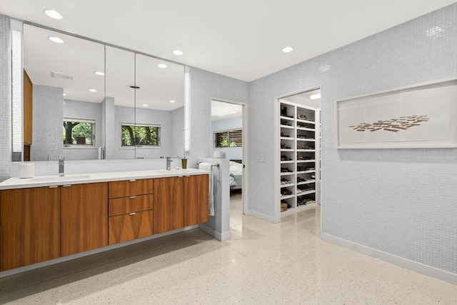 5322 Western Hills Dr, Austin, TX 78731 - bathroom featuring baseboards, double vanity, a sink, and visible vents
