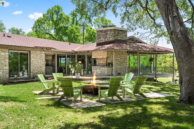 5322 Western Hills Dr, Austin, TX 78731 - back of property with a chimney, stone siding, a patio area, an outdoor fire pit, and a lawn