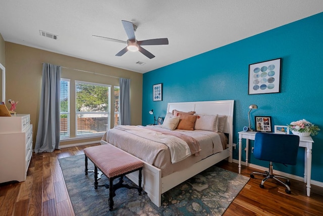 20300 Wayzata Ct, Pflugerville, TX 78660 - bedroom featuring an accent wall, wood finished floors, ceiling fan, and an office area