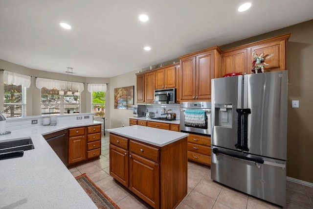 20300 Wayzata Ct, Pflugerville, TX 78660 - kitchen featuring appliances with stainless steel finishes, brown cabinets, light countertops, and recessed lighting