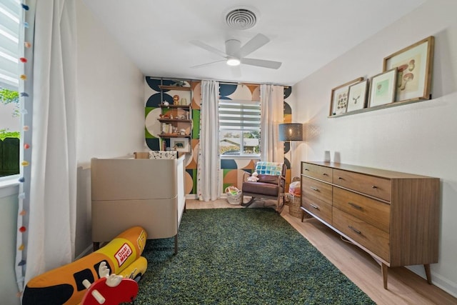 bedroom with visible vents, ceiling fan, and wood finished floors