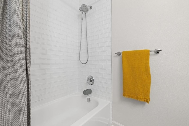 full bathroom featuring shower / bath combo with shower curtain and baseboards