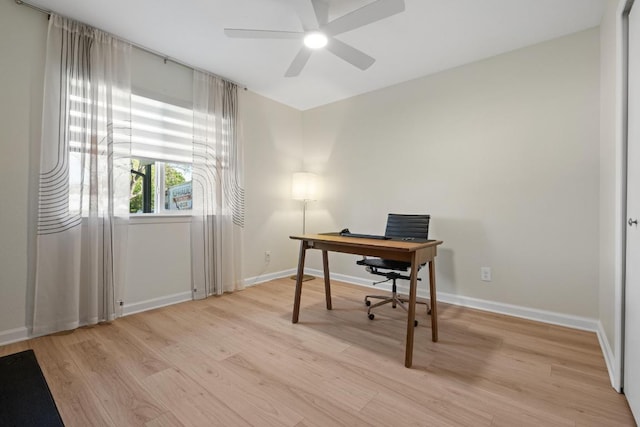 office featuring light wood-style floors, baseboards, and ceiling fan