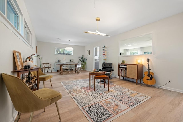 home office with baseboards and light wood-type flooring