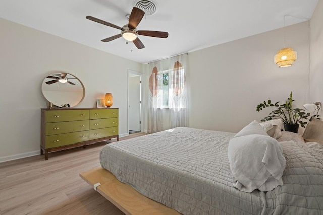 bedroom featuring visible vents, ceiling fan, light wood-type flooring, and baseboards