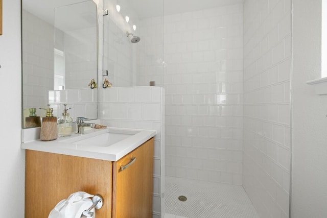 bathroom featuring backsplash, walk in shower, and vanity