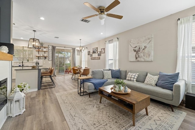 116 Buttercup Trl, Georgetown, TX 78633 - living area featuring a chandelier, healthy amount of natural light, a ceiling fan, light wood finished floors, and recessed lighting