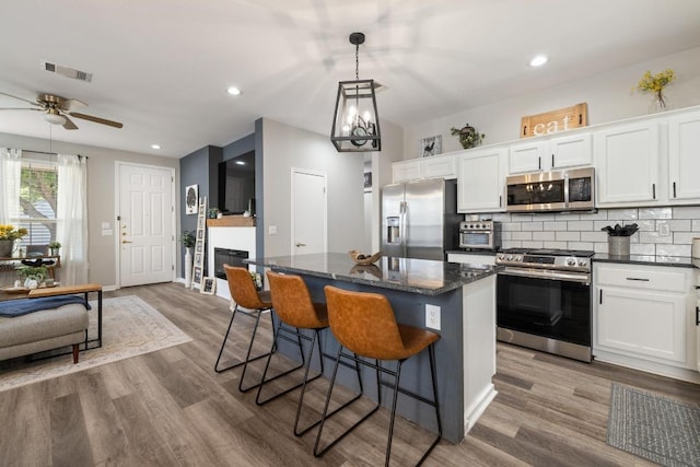 116 Buttercup Trl, Georgetown, TX 78633 - kitchen with appliances with stainless steel finishes, a center island, white cabinets, ceiling fan, and recessed lighting
