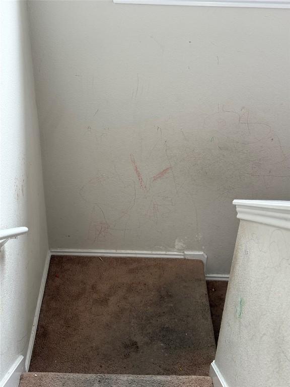 stairs with baseboards and carpet flooring