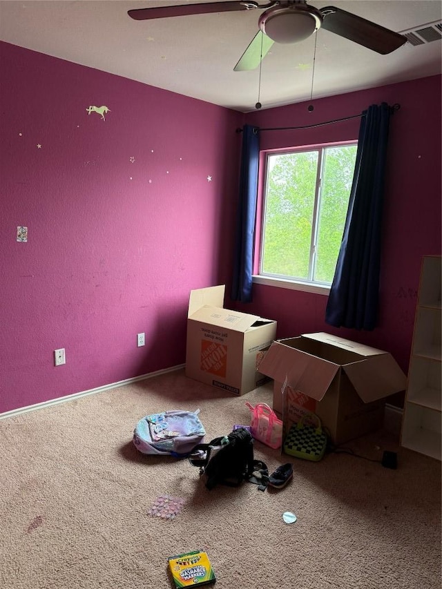 interior space featuring carpet flooring, visible vents, and ceiling fan