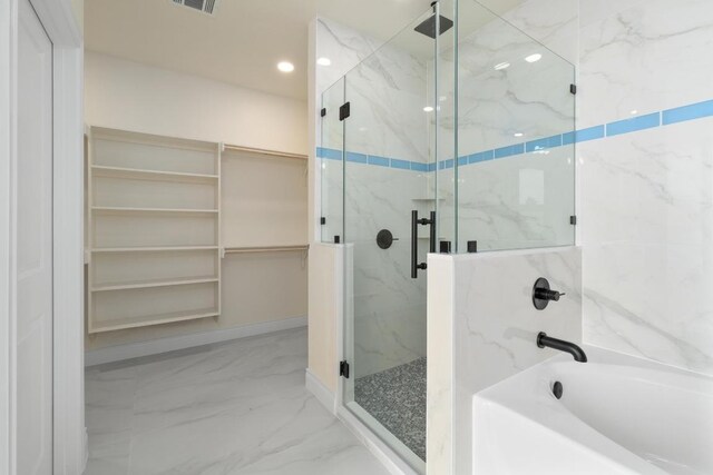 459 Rancho Linda Dr, Lockhart, TX 78644 - bathroom with a spacious closet, visible vents, a garden tub, and a marble finish shower
