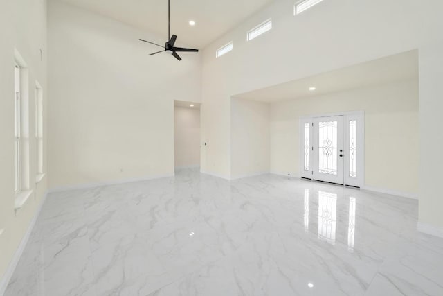 459 Rancho Linda Dr, Lockhart, TX 78644 - unfurnished room featuring a towering ceiling, baseboards, recessed lighting, a ceiling fan, and marble finish floor