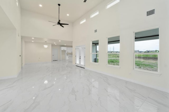 459 Rancho Linda Dr, Lockhart, TX 78644 - spare room featuring ceiling fan, marble finish floor, visible vents, and a healthy amount of sunlight