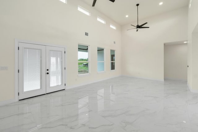 459 Rancho Linda Dr, Lockhart, TX 78644 - unfurnished living room with french doors, marble finish floor, a ceiling fan, and a healthy amount of sunlight