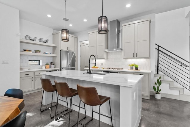 608B W 15th St, Georgetown, TX 78626 - kitchen featuring wall chimney exhaust hood, concrete floors, stainless steel appliances, a sink, and recessed lighting