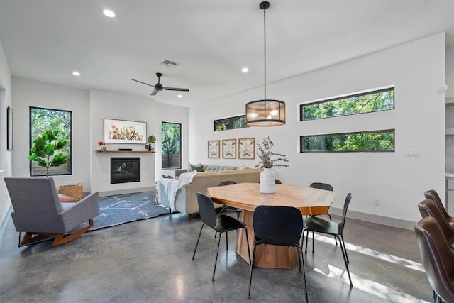 608B W 15th St, Georgetown, TX 78626 - dining area with recessed lighting, concrete floors, a glass covered fireplace, ceiling fan, and baseboards