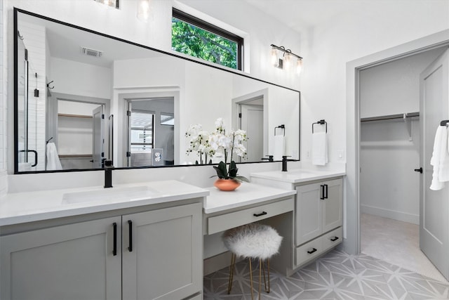 608B W 15th St, Georgetown, TX 78626 - full bathroom with a walk in closet, vanity, a stall shower, and tile patterned floors
