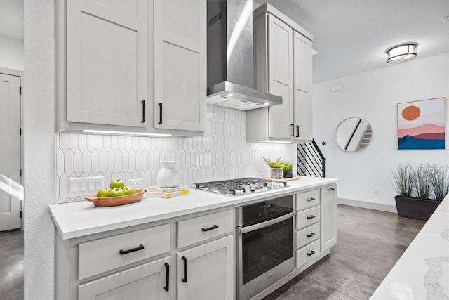 608B W 15th St, Georgetown, TX 78626 - kitchen featuring appliances with stainless steel finishes, wall chimney range hood, concrete flooring, and decorative backsplash