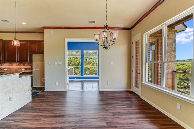 unfurnished dining area featuring visible vents, baseboards, a notable chandelier, dark wood-style flooring, and ornamental molding