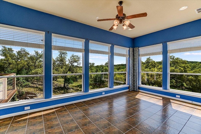 unfurnished sunroom featuring visible vents and baseboards