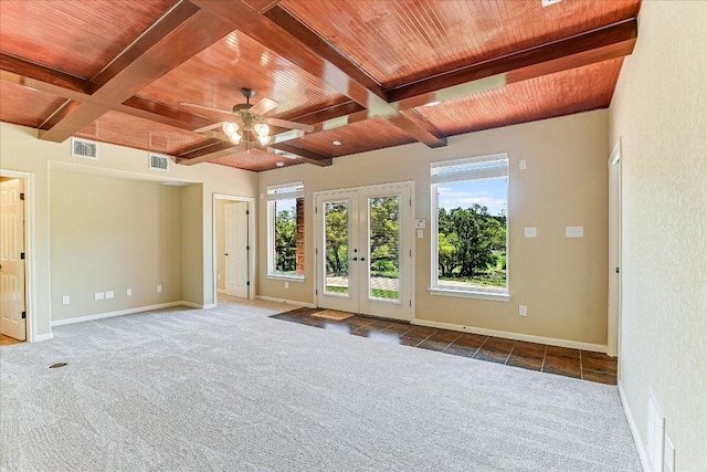 carpeted empty room featuring visible vents, a ceiling fan, wood ceiling, beamed ceiling, and french doors