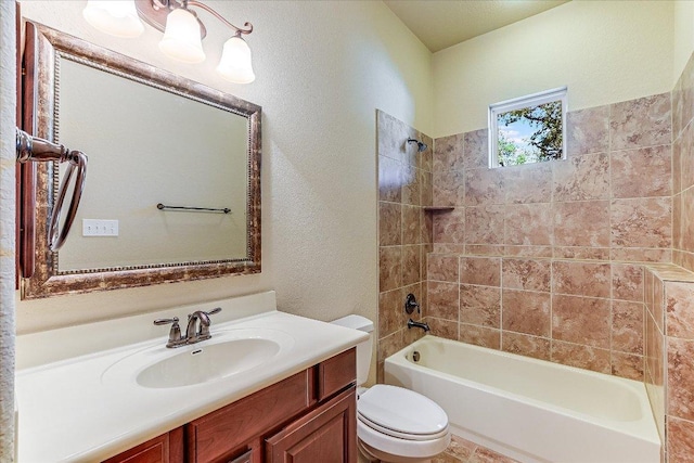 bathroom featuring toilet, vanity, a textured wall, and  shower combination