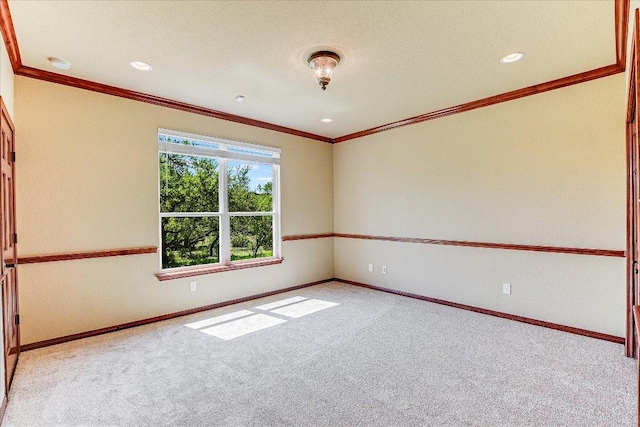 spare room featuring ornamental molding, carpet floors, baseboards, and recessed lighting
