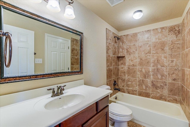 bathroom featuring a textured ceiling, vanity, visible vents, toilet, and shower / bathing tub combination