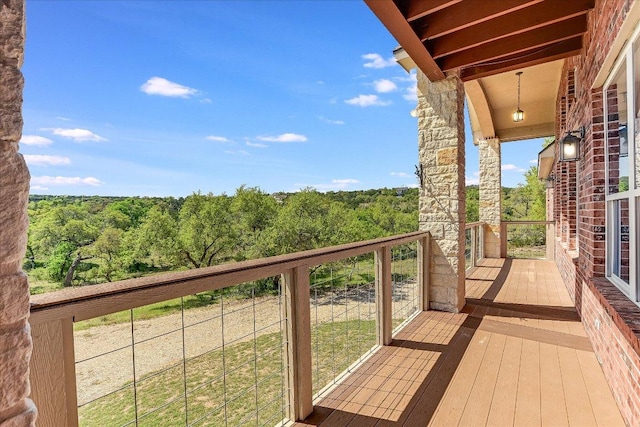 balcony featuring a forest view