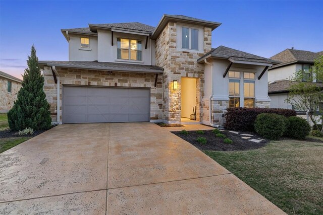 234 Sumalt Gap Way, Lakeway, TX 78738 - prairie-style house featuring stone siding, stucco siding, an attached garage, driveway, and a shingled roof