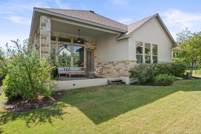 234 Sumalt Gap Way, Lakeway, TX 78738 - rear view of house featuring stone siding, ceiling fan, an outdoor hangout area, a yard, and roof with shingles