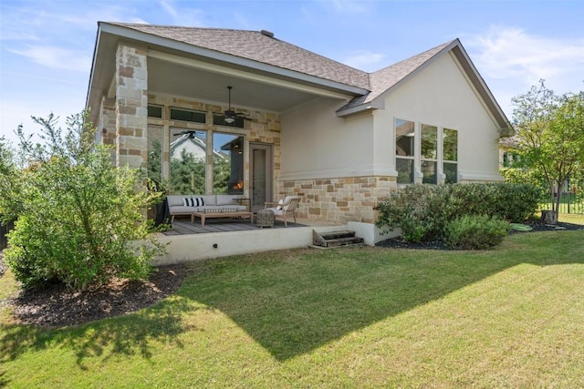 234 Sumalt Gap Way, Lakeway, TX 78738 - back of property featuring stone siding, ceiling fan, an outdoor living space, and a lawn