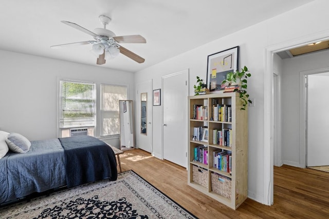 5708 Ave F, Austin, TX 78752 - bedroom featuring wood finished floors, cooling unit, and a ceiling fan