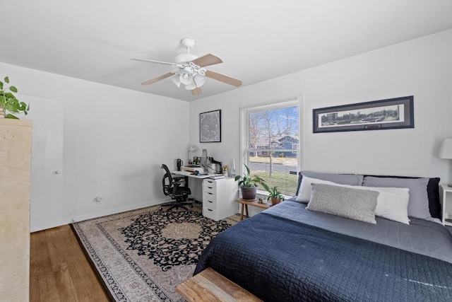 5708 Ave F, Austin, TX 78752 - bedroom featuring an office area, wood finished floors, and a ceiling fan