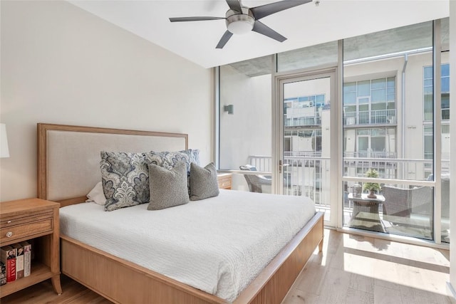 bedroom featuring access to outside, ceiling fan, and light wood finished floors