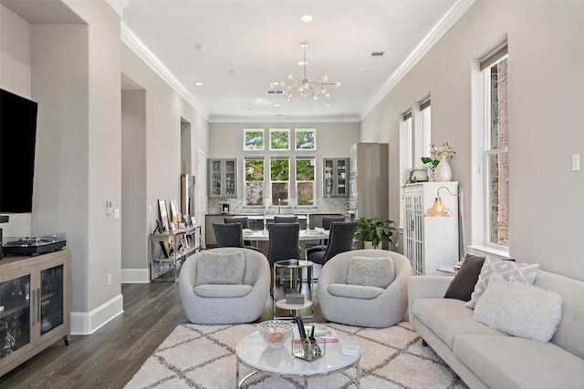 1015 Juniper St, Austin, TX 78702 - living room with crown molding, a notable chandelier, baseboards, and dark wood-type flooring