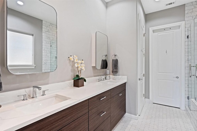 1015 Juniper St, Austin, TX 78702 - full bathroom with visible vents, an enclosed shower, double vanity, and a sink