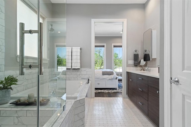 1015 Juniper St, Austin, TX 78702 - full bathroom with vanity, a bath, ensuite bath, ornamental molding, and a shower with door