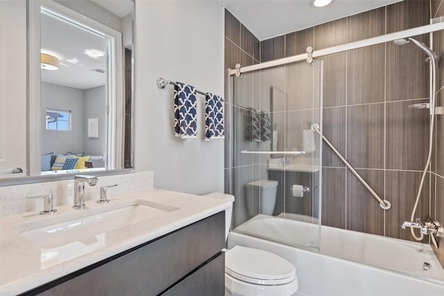 1015 Juniper St, Austin, TX 78702 - ensuite bathroom featuring toilet, bath / shower combo with glass door, vanity, and ensuite bath