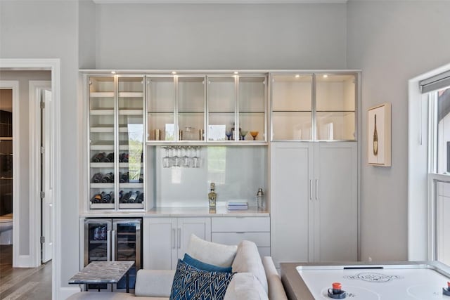1015 Juniper St, Austin, TX 78702 - bar with wood finished floors, cooktop, and wine cooler